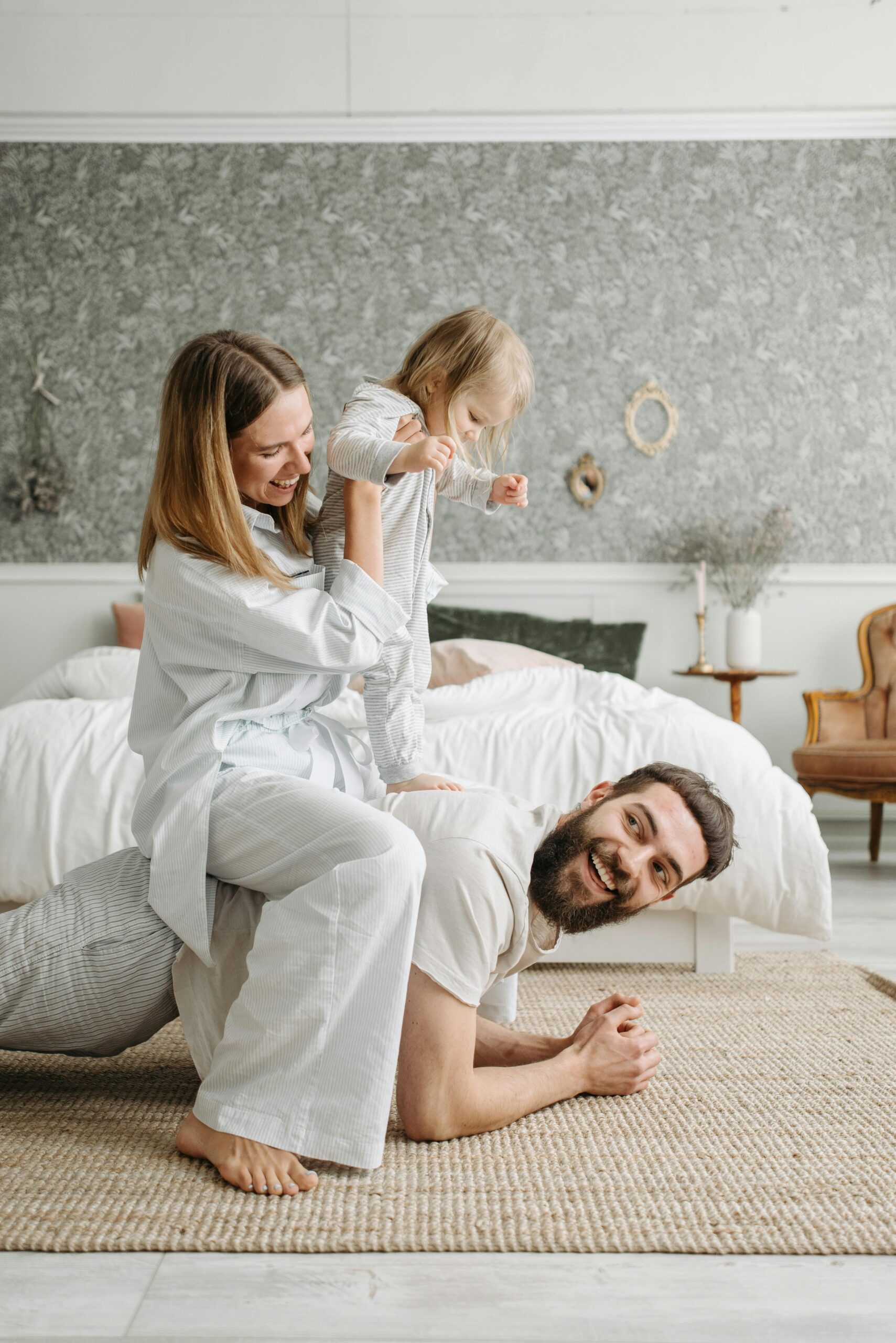 A happy family spending a joyful morning playing together in their bedroom.